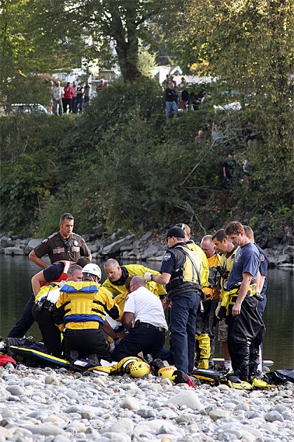 Emergency teams try to revive a man in his 20s who had fallen into the Snoqualmie River Wednesday afternoon