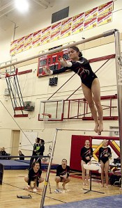 Mount Si High School varsity gymnast Georgia Reynolds leaps on the bars during competition against Newport and Interlake Thursday