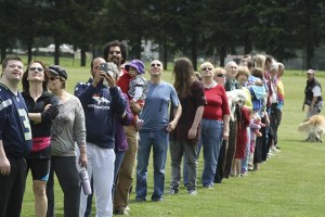 Participants in Mary Miller’s Heart of the Valley photo shoot keep an eye on the photographer herself as they form a giant heart Sunday afternoon