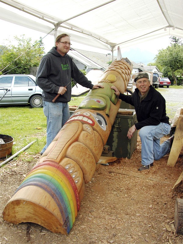 Bob Antone and Mark Rohrbach work on a 20-foot totem