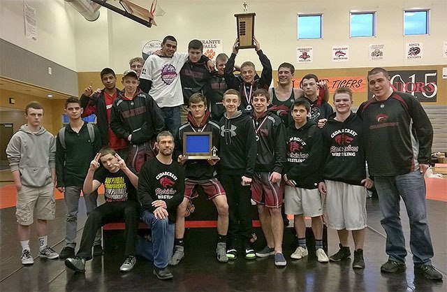The Cedarcrest High School wrestling squad and coaches celebrate their victory at sub-regional competition Feb. 7.