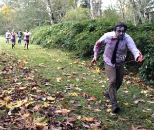 Ghoulishly made-up competitors roam the leafy obstacle course at Mountain Meadows Farm during North Bend's first Zombie Challenge run