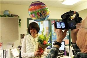 North Bend Elementary secretary Karen Seiser is surprised with balloons and flowers when the Snoqualmie Valley Schools Foundation announced its educator of the year awards.