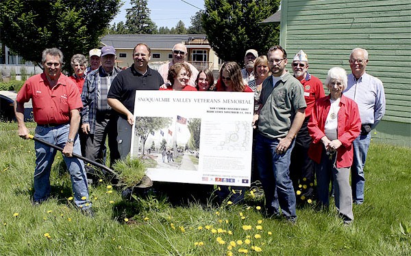 Construction crew members pose with friends and supporters of the Snoqualmie Valley Veteran’s Memorial Committee Friday
