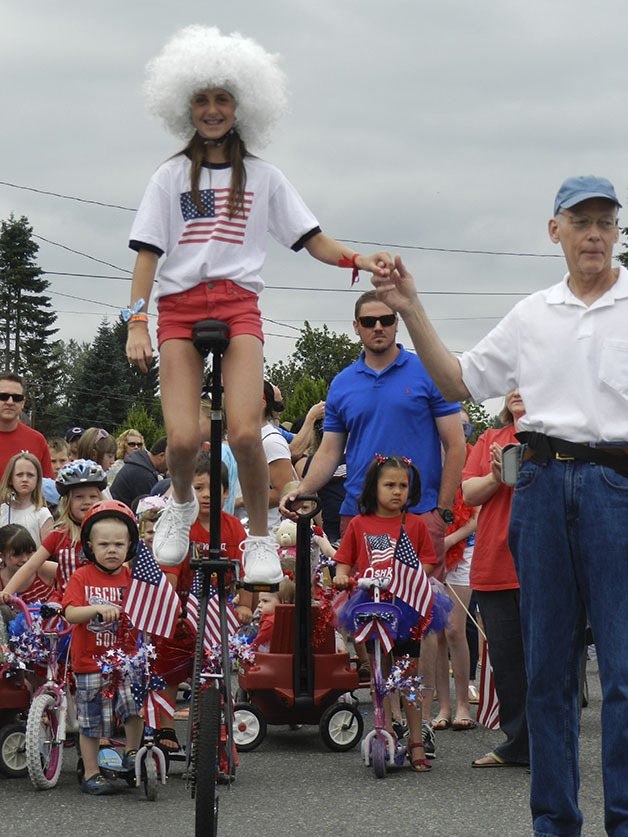 Unicycle and tricycle riders begin the children's parade on the Fourth of July in Carnation. The kiddie parade is 10:30 a.m. Friday