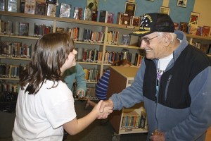 Snoqualmie Elementary student Haylee Osborn shakes hands with Bill Staggs