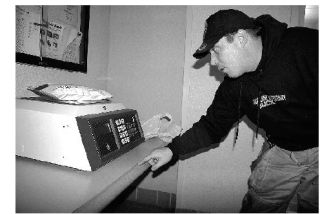 North Bend resident Ryan Hooper weighs packages Wednesday