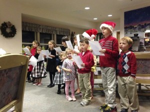 Valley children carol at Red Oak Residence before Christmas. Several local families came together to recreate an old holiday tradition.