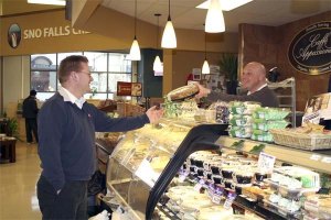 Deli manager Joe Cvar shows Snoqualmie Ridge IGA store manager Charlie McKissick a new product