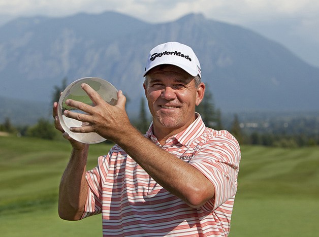 Scott Dunlap holds the 2014 Boeing Classic trophy after winning the tournament in a playoff Sunday