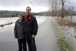 Jeff Groshell and his son Trevor inspect the flooded entrance to their family’s golf course at Fall City. Groshell was surprised by how high flood levels rose in the Lower Valley during the Martin Luther King Jr.