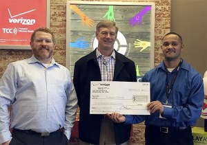 Presenting a check to Friends of Youth at the TCC grand opening are