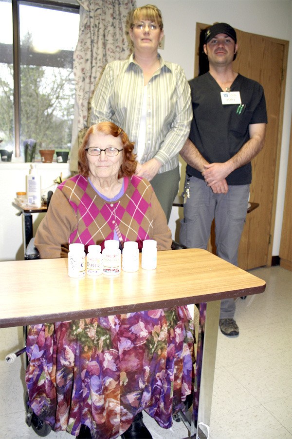 Going over her row of daily medications