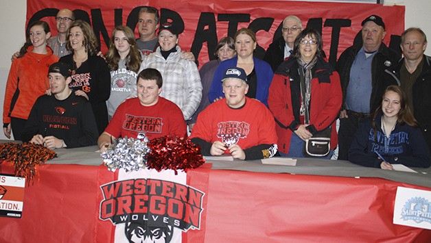 Family members pose with their athletes