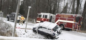 Snoqualmie firefighters respond to a vehicle off the roadway at Stone Quarry Road and Highway 202. Slick roads made for a challenging morning in the Valley on Wednesday