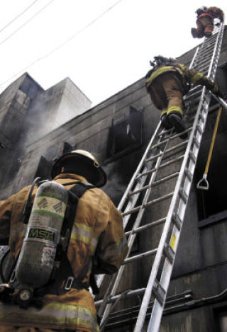Cadets at the state Fire Training Academy in North Bend assault the school’s burn building — where recruits learn how to fight structure fires.