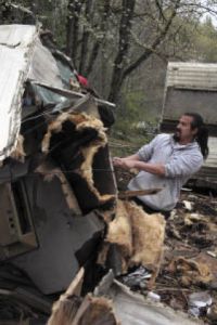 Snoqualmie Tribe member Jacob Mullen goes to work on a ruined camp trailer with a splitter during Earth Day restoration efforts on tribal elder Earl Moses’ land. “It’s nice to clean up Earl’s property