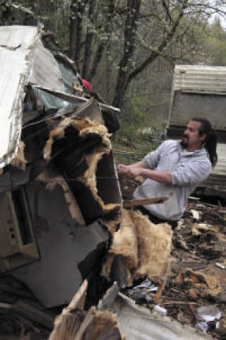 Snoqualmie Tribe member Jacob Mullen goes to work on a ruined camp trailer with a splitter during Earth Day restoration efforts on tribal elder Earl Moses’ land. “It’s nice to clean up Earl’s property