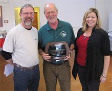 Mayor Ken Hearing and Administrator Londi Lindell stand beside Fergus McGrath