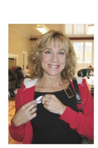 Brenda Williams puts on a sticker letting the world know that she voted on Election Day