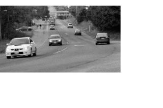 Cars approach the intersection of State Highway 202 and Mill Pond Road in Snoqualmie