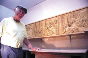 Adi Hienzsch stands in front of his carving of Snoqualmie Valley’s history for North Bend’s Centennial block party. The carving