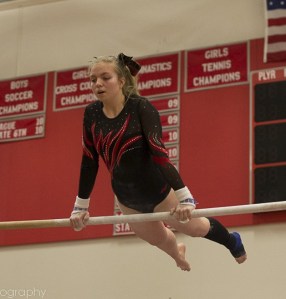 Mount Si senior Daniele Curley competes on bars on Thursday