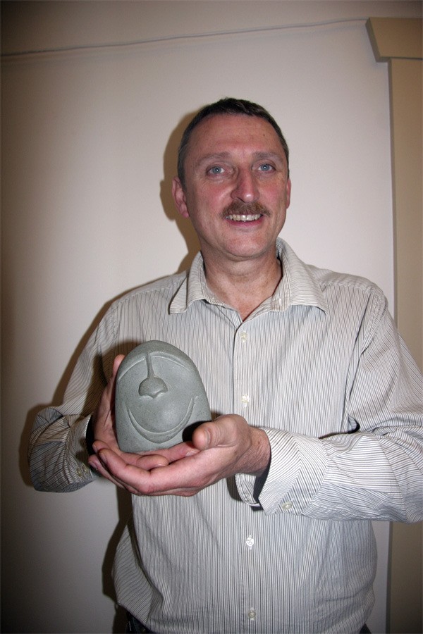 Snoqualmie United Methodist Church Pastor Phil Harrington holds a carved river stone