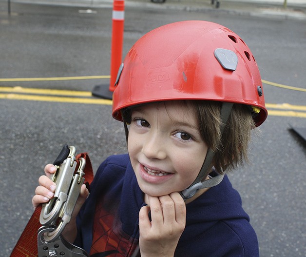 A helmeted Sydney Wysocki of North Bend gets ready for her next run down the John Day Homes-sponsored block long zip line
