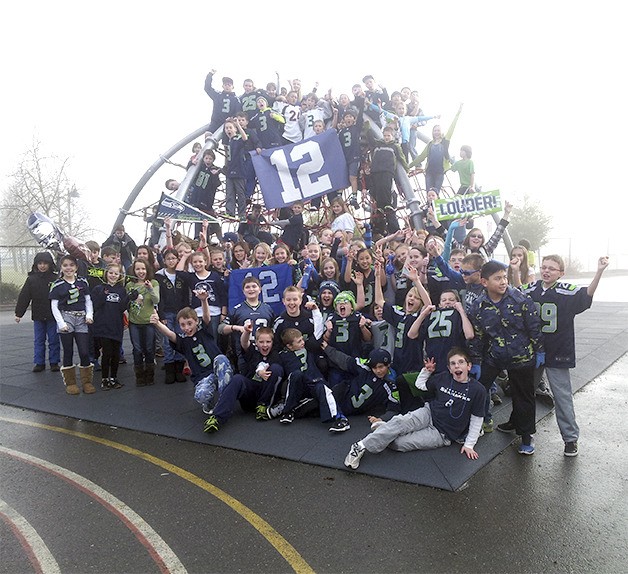 The fifth grade class at Cascade View Elementary show their 12th Man spirit. This photo was taken on the school playground on Friday