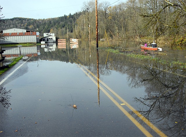 A father and daughter float along the edge of Tolt Hill Road Wednesday