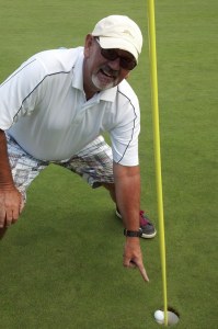 Golfer Steve Funk points to his hole-in-one shot at the TPC Snoqualmie Ridge.