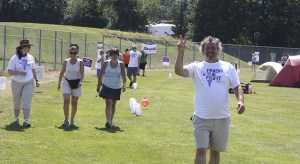 Todd Shelver flashes a victory sign on his lap for the Dress Barn team.