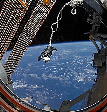 A glass raven amulet