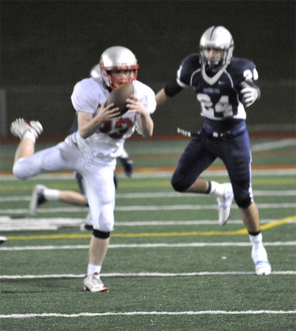 Mount Si junior Connor Deutsch pulls down a Glacier Peak pass in front of CJ Hawley to keep the Grizzlies from a late score in regulation play Friday