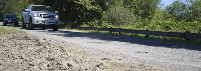 Eastbound drivers swerve left to clear a rutted section of roadway on North Bend’s Boalch Avenue. The worn-out street