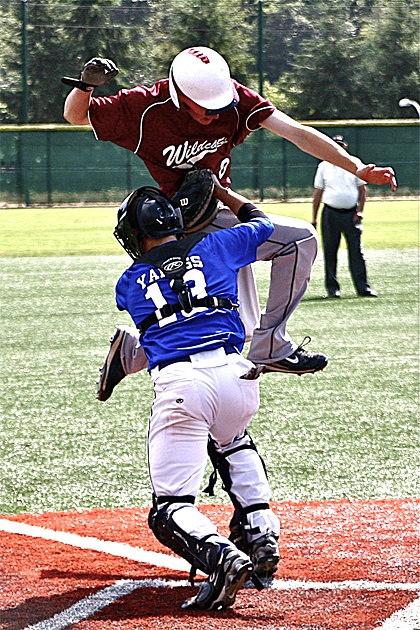 Wildcat runner Zach Stevens collides with Bandits catcher Sean Yanuss during a July 14 matchup