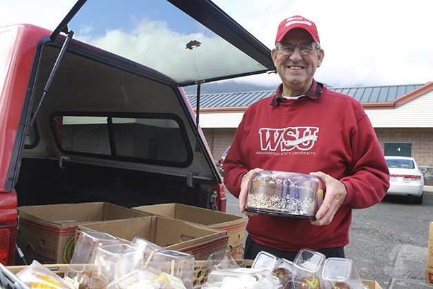 Volunteer Dave Kelley of North Bend loads his truck with baked goods bound for Snoqualmie Valley Food Bank. “That little red truck goes all over
