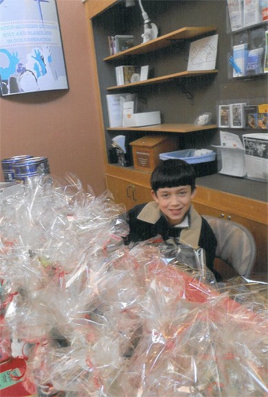 Dylan Riley gets ready to sell hundreds of packages of cookies. He and his mother baked about 100 packages each week to sell as a fund-raiser for Pilgrim