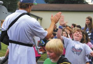A Snoqualmie Elementary student reacts to a high-five from Seattle Seahawk player John Carlson