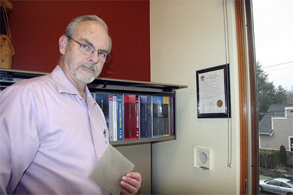 Snoqualmie building official Dan Thomason shows off a fresh-air intake in the building department of the new city hall. Fresh air enters the building at all times.