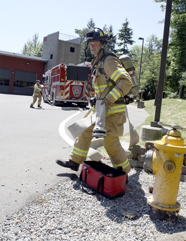Rushing to connect fire hose to hydrant
