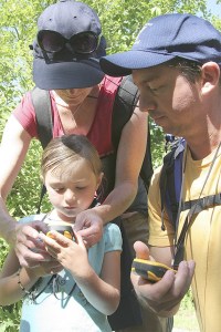 A family works on their geocaching skills during an outing in the Valley. Join Berry Rogers to learn about geocaching at Saturday's North Bend Block Party.