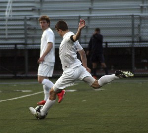 Team co-captain Aaron Baumgardner kicks a 30-yard screamer into the Bellevue net.