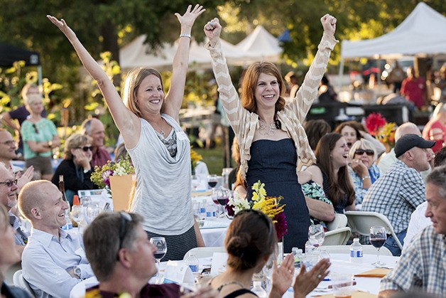 Sammamish residents Casey Crane and Jennie Moore celebrating a winning bid for an item donated by a local merchant in the Taste of the Valley benefit auction