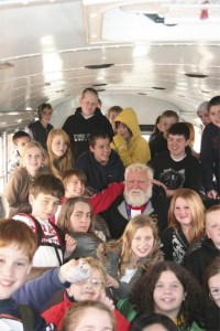 Riders on a Twin Falls Middle School afternoon route surround bus driver Chuck Smith. Funding for bus drivers is part of the upcoming February school levy. Pictured are