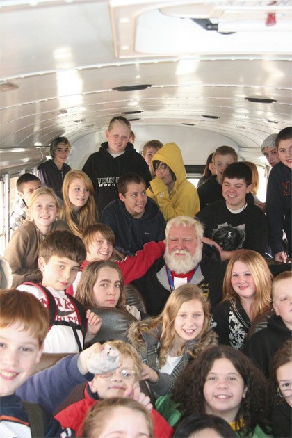 Riders on a Twin Falls Middle School afternoon route surround bus driver Chuck Smith. Funding for bus drivers is part of the upcoming February school levy. Pictured are