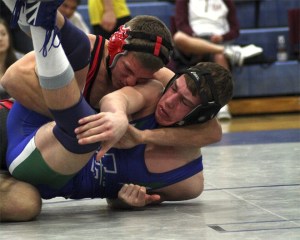 Mount Si senior AJ Brevick handles Quinn Magendanz of Liberty to claim third at 160 pounds during league tournament mat action Saturday