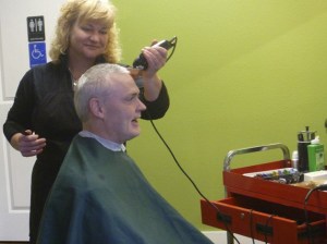 Keith Heston receives a precision cut by Debbie Bass. Heston was one of Bass' first customers. He was so thrilled that she was available to do haircuts again