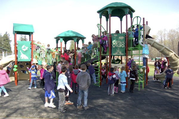 Ribbon Cutting: Officially cutting the ribbon on the new playground at Fall City Elementary School are